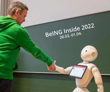 humanoider Roboter gibt Menschen die Hand