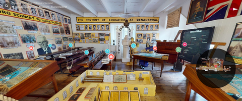 View of a virtual 3D environment of an interior space within the  Gnadendal Mission Museum, featuring self-learning elements for Kurrent  script and other educational content.