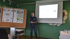 Foto zeigt eine Präsentation eines Studenten, welcher seine Arbeit präsentiert.