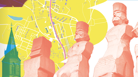 Bild mit Schnitzfiguren und einem Stadtplan von JGS