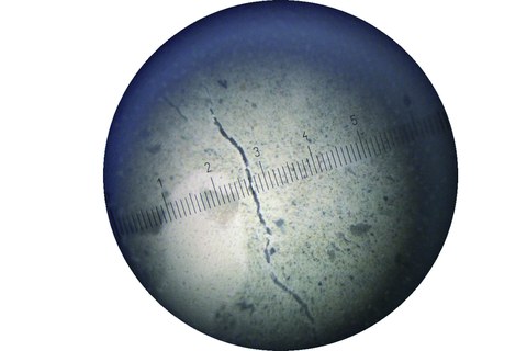 Small crack through a crack measuring magnifier