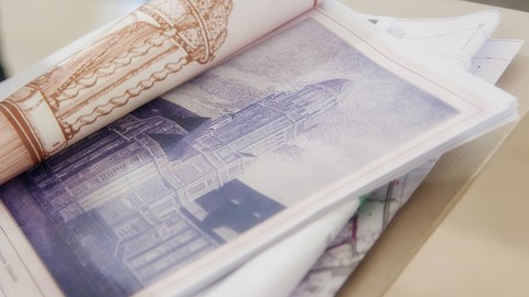 Photo shows a brochure with historical views of the Beyer building