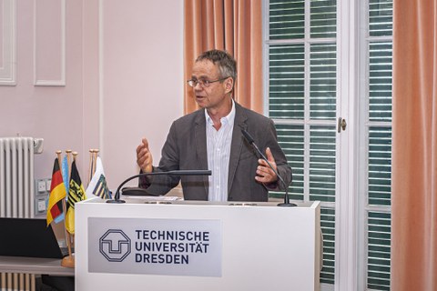 Prof. Dr. Karsten Kalbitz steht am Rednerpult der TU Dresden und spricht zu den Veranstaltungsteilnehmenden.