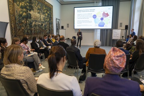 Conference room packed with international participants.