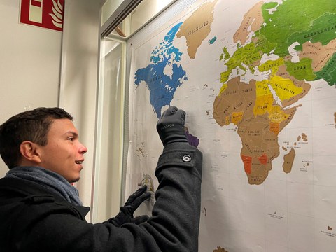 Eliezer scratching his country Venezuela from the programme student’s map