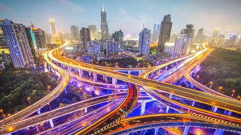 A bg city at nght with lightend up streets crossing