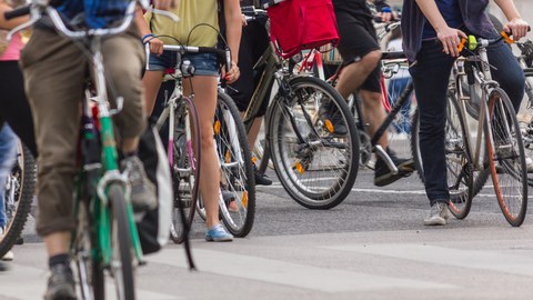 Many bikes next to each other. People just half to see