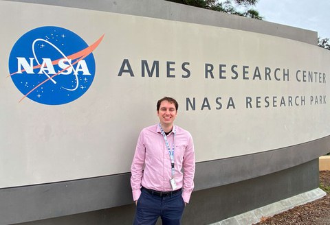 Kevin-Christian Garzon Galindo in front of the entrance to the NASA Ames Research Center 