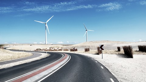 Windmills near a coastal road