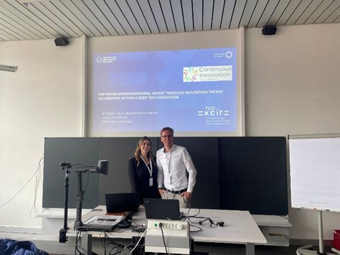 Moderators in front of a whiteboard and PowerPoint presentation