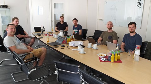 Here is a picture of people in a meeting room