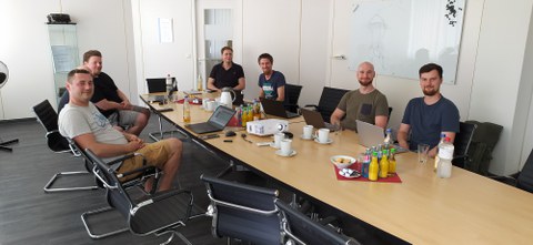 Here is a picture of people in a meeting room