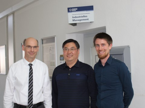 Three men smiles.