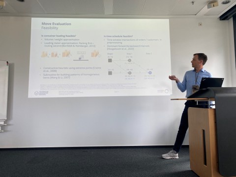 Presenting man in front of presentation slide