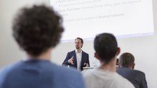 You see a man holding a speech