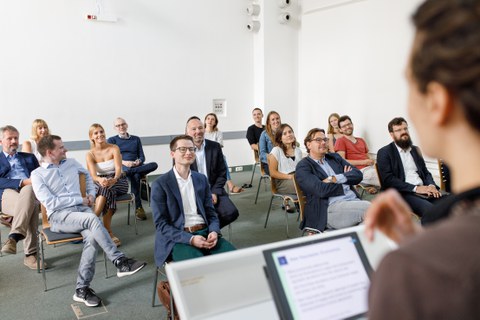 You see people sitting in a colloquium