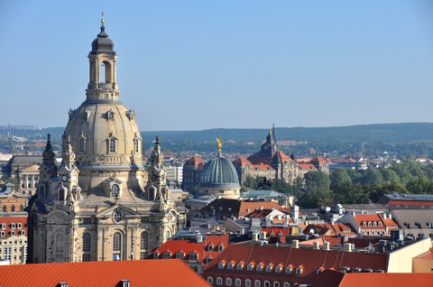 Auf dem Foto ist eine Luftaufnahme der Frauenkirche und der umliegenden Gebäude zu sehen.