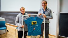 Prof. Dr. Marius Ader receiving the money collected throughout the rowing challenge 