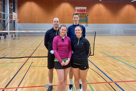 Foto 2 Frauen und 2 Männer stehen in einer Sporthalle vor einem Volleyballnetz
