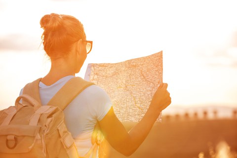 Woman with a backpack and a hiking map