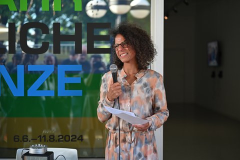 Curator Tanja-Bianca Schmidt in front of the exhibition "Dangerous Border"