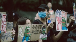 protestors holding signs condemning police brutality using pepe the frog meme 