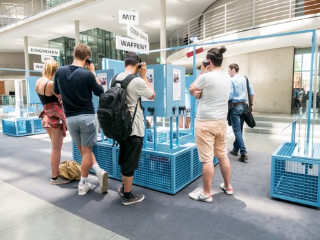 Eine Gruppe geht durch die Ausstellung Frieden Machen 