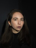 Porträtfoto der wissenschaftlichen Mitarbeiterin Leyla Sophie Gleissner vor schwarzem Hintergrund