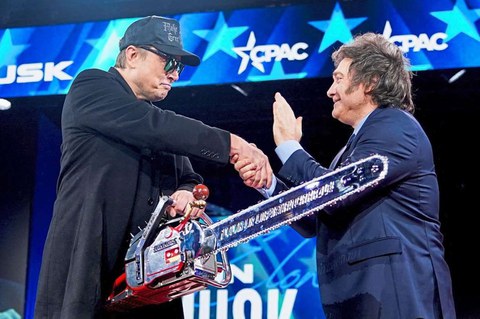 Elon Musk shakes hands with Argentinian president Javier Milei as he is gifted a chainsaw