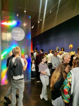 Entrance to the “Can You Feel It?” exhibition, with numerous guests.