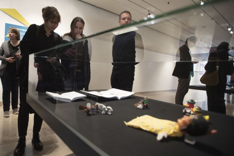 Foto von der Vernissage - Besucher betrachten eine Vitrine