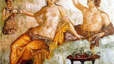 Wall painting depicting a banquet. A man drinks from a type of drinking vessel with two openings called a rhyton. His female companion wears a sheer garment and a golden net over her hair. A female servant attends to the couple, proffering a small box. The table in front holds a set of silver vessels for mixing wine. The whole scene represents an idealized Greek drinking party, a pleasurable sight for the guests of this first century Roman household. 