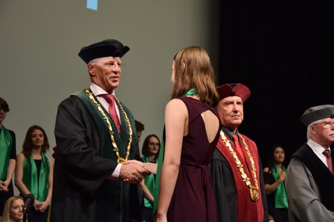 Ceremony of graduation for the double degree at the TU Liberec. The Dean of the Faculty of Economics, Professor Kocourek, congratulates a student.
