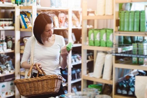 A woman looking for sustainable lables on a product
