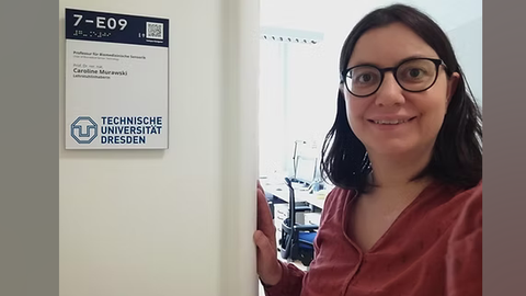 Ms. Caroline Murawski with a bright smile in front of her new office at Dresden University of Technology.