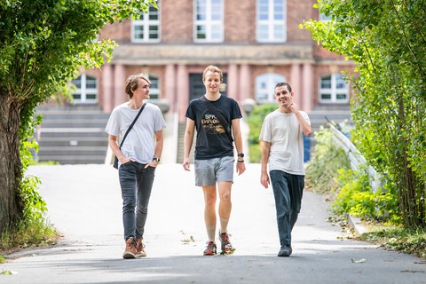 Drei SECAI-Wissenschaftler auf dem Weg vor dem Görkes-Bau