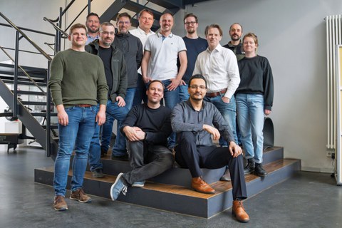A group of scientists looks into the camera.