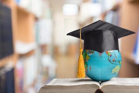 Book with globe and graduate hat