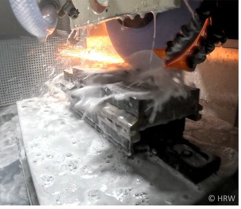 Photo of a welding process completely surrounded by water and foam.