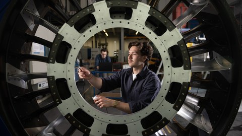 A man is working on an IMC hybrid component.