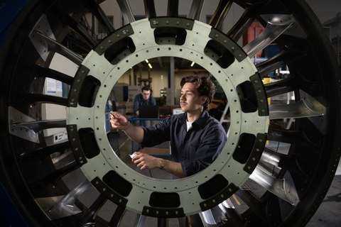 A man is working on an IMC hybrid component.