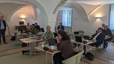 View into the conference room, participants listening to a talk