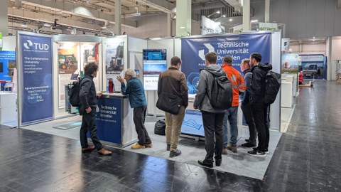 Menschengruppe am AST Messestand