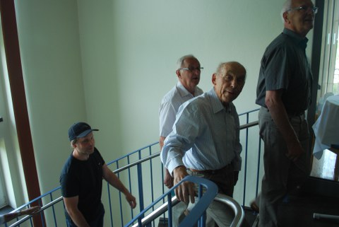 Drei Männer gehenh eine Treppe hinauf.