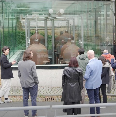 Group of people viewing the Glass Pavilion at TU Dresden campus