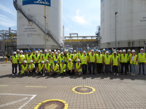 Group photo of the ECC participants in yellow safety vests with helmets.
