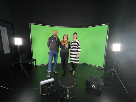 Group picture in front of a green screen