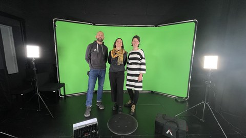 Group picture in front of a green screen