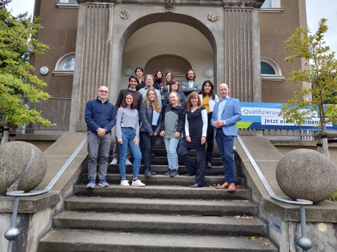 Group picture of the team on a staircase