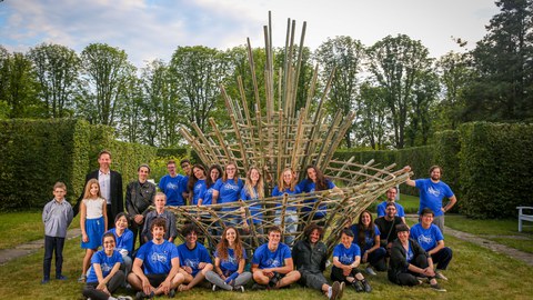 Group picture in front of bamboo sculpture